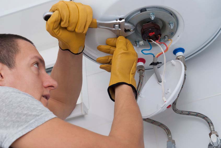 a technician fixing a water heater a technician fixing a water heater
